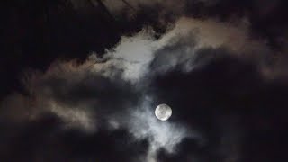 Full Moon Backlighting the Night Clouds