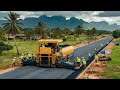 Paving gravel pavers: An incredible huge paving machine that receives gravel from dump trucks