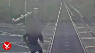 Woman comes 'within half a second of being hit by train' at level crossing