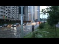 man wakeboarding down a busy flooded moscow street