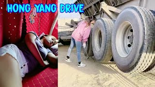 Construction material transportation. Beautiful female truck driver Hong Yang