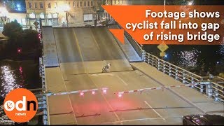 Shocking footage shows cyclist fall into gap of rising bridge