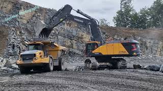 Volvo EC950F loads a Bell B60E Dumper in a Quarry, Switzerland, 2022.