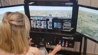 My wife Landing the Cessna 182RG on the Redbird simulator.