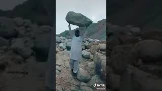 Afghan Superman Lift up a Rock from a Mountain