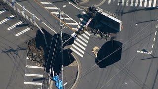 Truck swallowed by sinkhole in Japan, with rescue efforts complicated by second hole