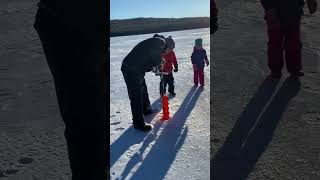 Drilling holes in the ice..