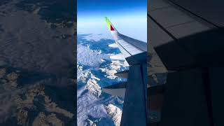 Flying Over Switzerland: Clouds and Snowy Mountains