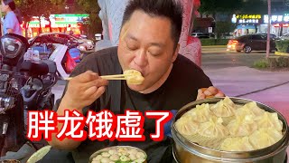 Fat dragon eats a cage of soup dumplings and a bowl of soup with meatballs.