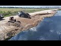 incredible landslip into water recover by 25t dump trucks unloading rock pushing by komatsu dozer