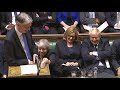 Theresa May hands cough sweets to Philip Hammond during budget speech