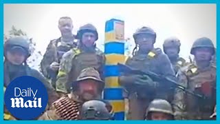Ukrainian soldiers put up blue and yellow post at Russian border