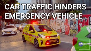 Emergency vehicle hindered by car traffic