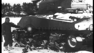 3rd Armored Division soldiers examine a damaged tank and march on snow covered ro...HD Stock Footage