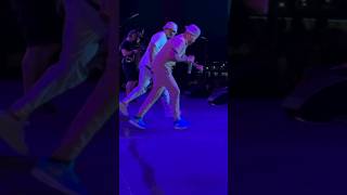 REDMAN AND METHOD MAN DO A DANCE ROUTINE ON STAGE....
