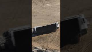 Side dump trailer dumping dirt