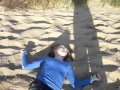 mary rolling down a sand dune.