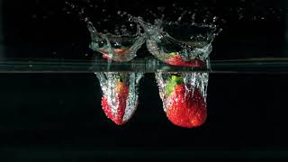 Strawberries Plunging Into Water [ 4K Video ]