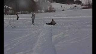 Snowboarders and skier on kicker in Istebna