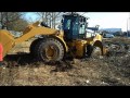 brand new cat 966k stuck in the mud. guy is learning to drive this peace of maschine