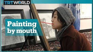 Afghan painter drawing with her mouth