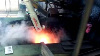 Induction heating machine for hot forging with robot