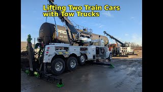 Lifting Two Train cars with Tow Trucks       90,000 pounds and 99,700 pounds