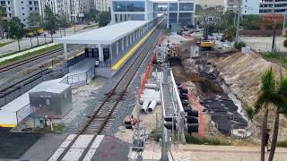 FEC Train 202 passing through Brightline's West Palm Beach station