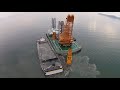 a huge excavator with a clamshell bucket dredging