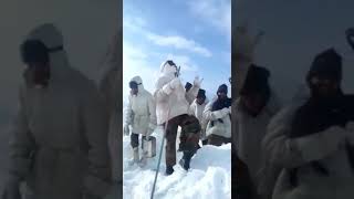 Group of ladakh scout army dancing at glacier .