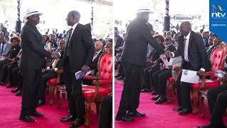 President Ruto and Raila Odinga shake hands during Mukami burial service