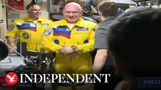 Russian cosmonauts arrive at the ISS wearing Ukrainian flag colours