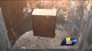 Workers uncover time capsule in monument