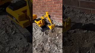 1/16 RC excavator loading a dump truck