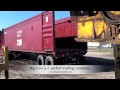 komatsu pc400 excavator loaded into an open top container