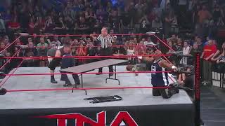 Bully Ray powerbombs Devon's Kid through table