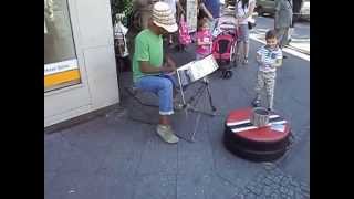 Street artist playing steelpan in Berlin Neukoelln.