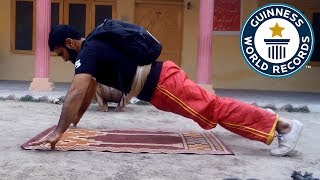Two finger push ups carrying a 40 pound pack - Guinness World Records