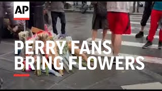 Matthew Perry fans bring flowers to the 'Friends' apartment building in New York