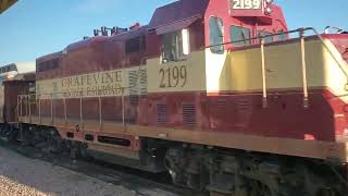 TexRail Train Arriving at Grapevine Station Passing Vintage Railroad Engines and Coaches