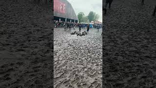 Festivalgoers Enjoying Mud Slide and a Lighthearted Chase