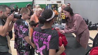 Caitlin Clark surprises DMPS kids with backpacks, school supplies