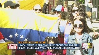 Local Venezuelans gather at Fountain Square to discuss dismay over civil unrest in their ancestral h