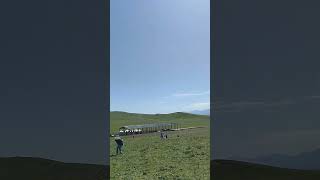 There are yurts on the grassland and outdoor emergency shelters