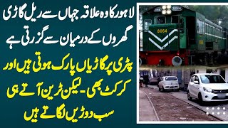 Lahore Ka Area Jaha Train Gharon K Darmian Se Guzarti, Patri Par Log Car Park Karte Or Bache Khailte