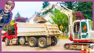 Excavator Loads Dump Truck At Construction Site