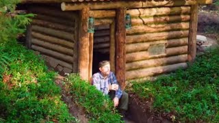 building a wooden house as a shelter to survive alone in the forest