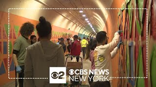 Upper Manhattan community helps paint murals inside 191st Street tunnel