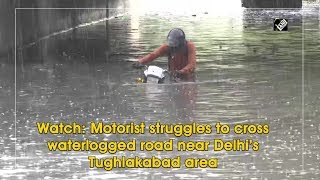 Watch: Motorist struggles to cross waterlogged road near Delhi’s Tughlakabad area