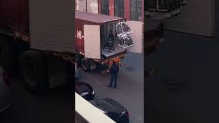 A unique method of loading clothes into trucks